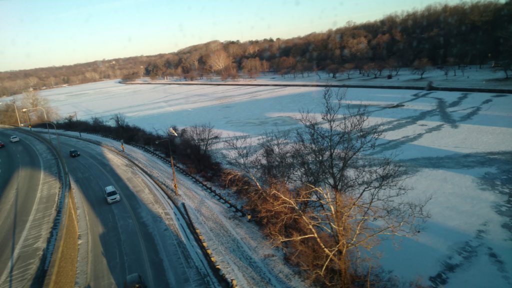 shadow of train bridge on snowy river